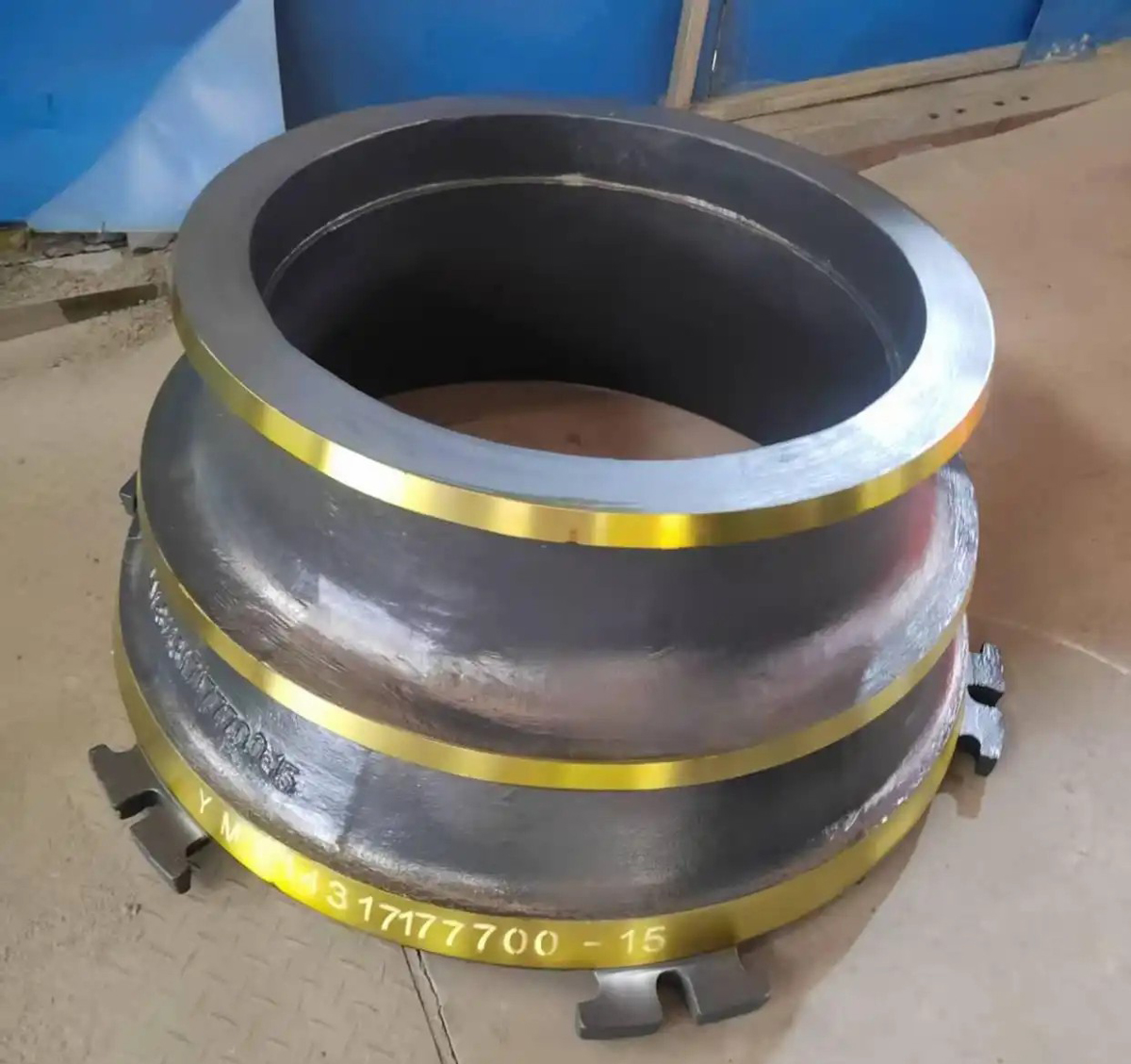 thyssenkrupp Kubria cone crusher mantle showing gouging wear from incorrect manganese steel specification