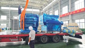 Yonsmen heavy mining equipment crusher parts loading onto flatbed truck for site delivery